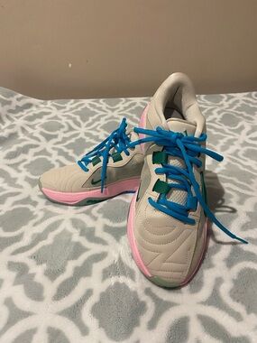 Nike Women's Beige Sneakers with Pink Trim and Blue Laces
